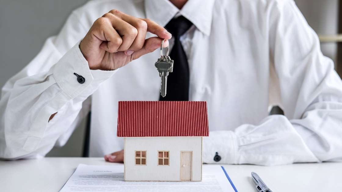 a real estate agent holding a house key